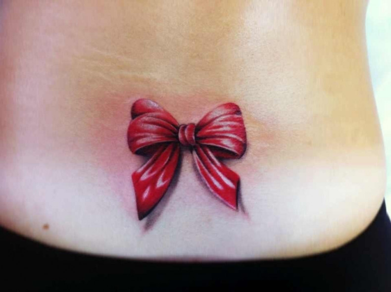 Women bow lower back, photo - Tattoo Master Barb Tattoo