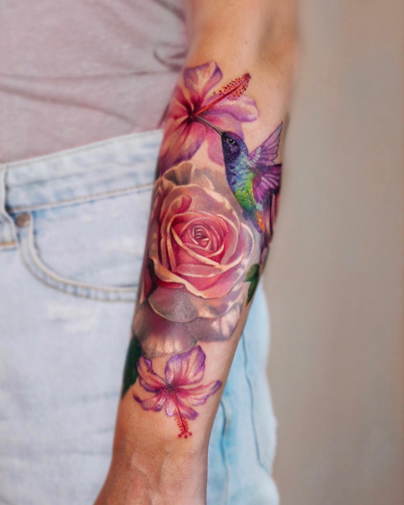 Colored flowers and hummingbird tattoo, photo - Tattoo Master Barb Tattoo