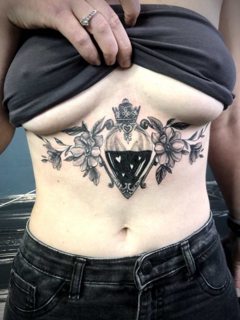 Bottle under breast, photo - Tattoo Master Barb Tattoo