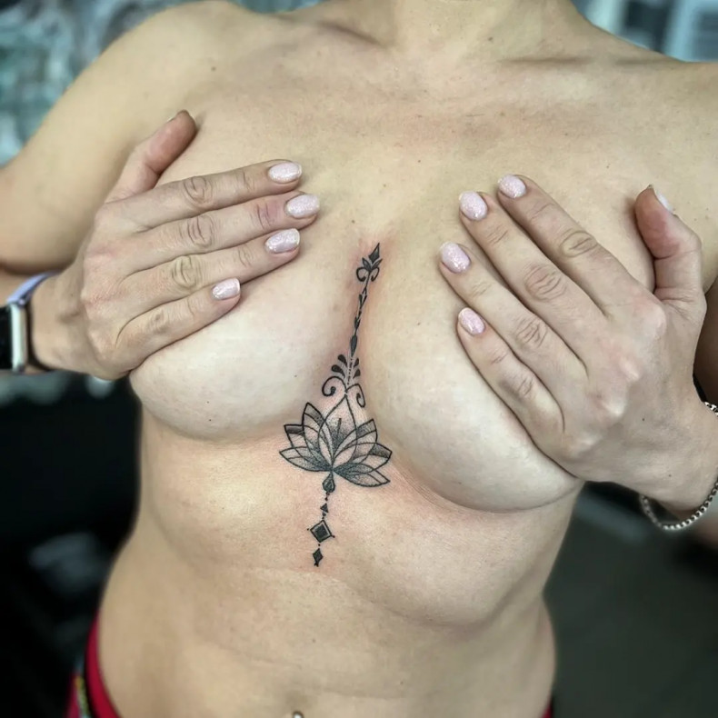 Linework lotus flower under breast, photo - Tattoo Master Barb Tattoo