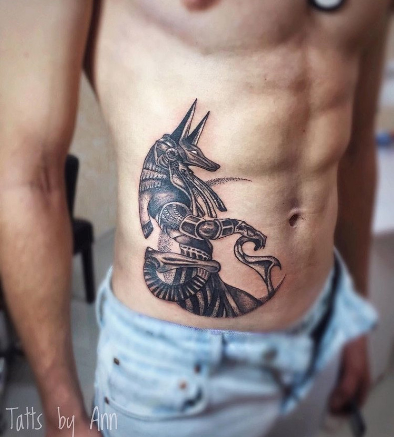 Anubis side rib, photo - Tattoo Master Barb Tattoo