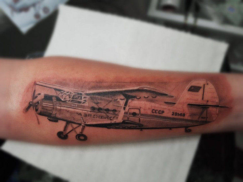 Airplane tattoo on arm, photo - Tattoo Master Barb Tattoo