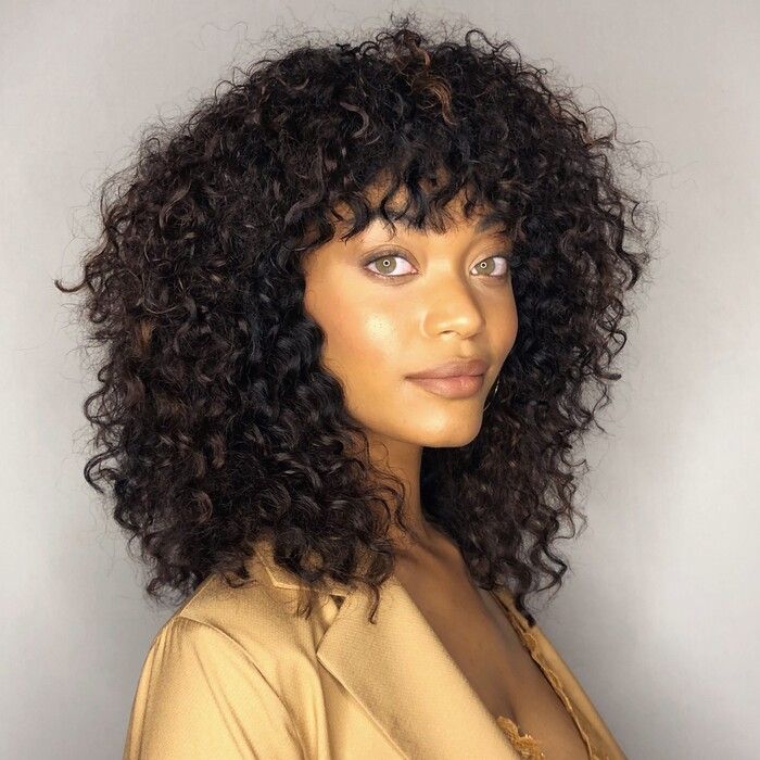 Photo of woman with Rounded Afro with Bangs