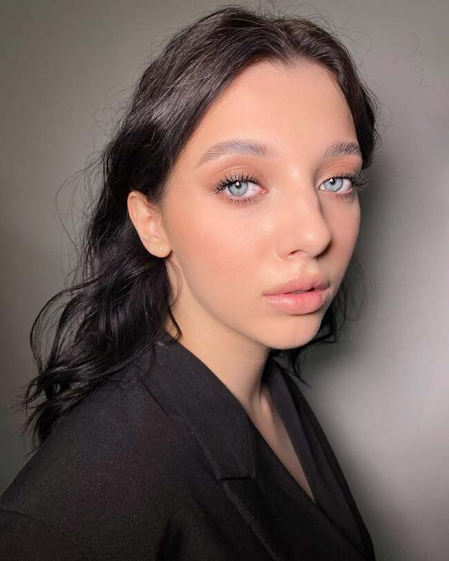 Light nude makeup emphasizing fluffy lashes and transparent lips