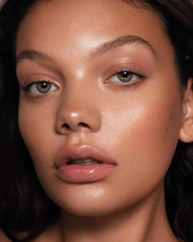 Nude makeup with dewy finish and glossy lips