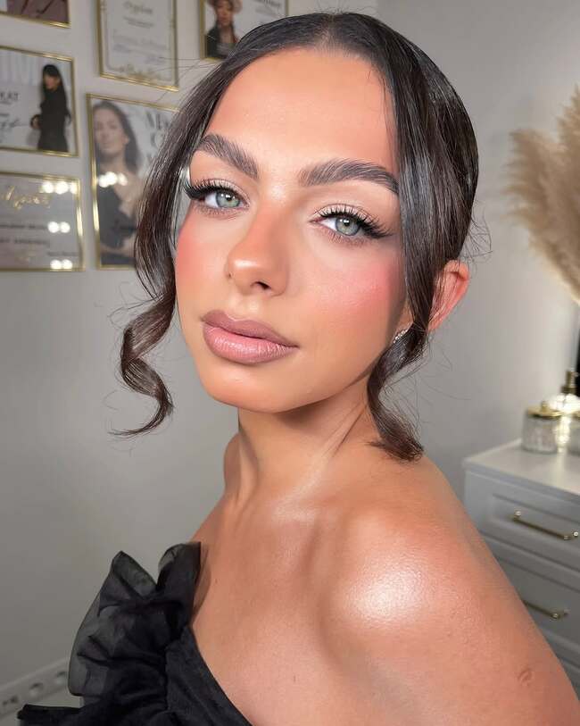 Expressive nude makeup with voluminous lashes and glowing cheekbones