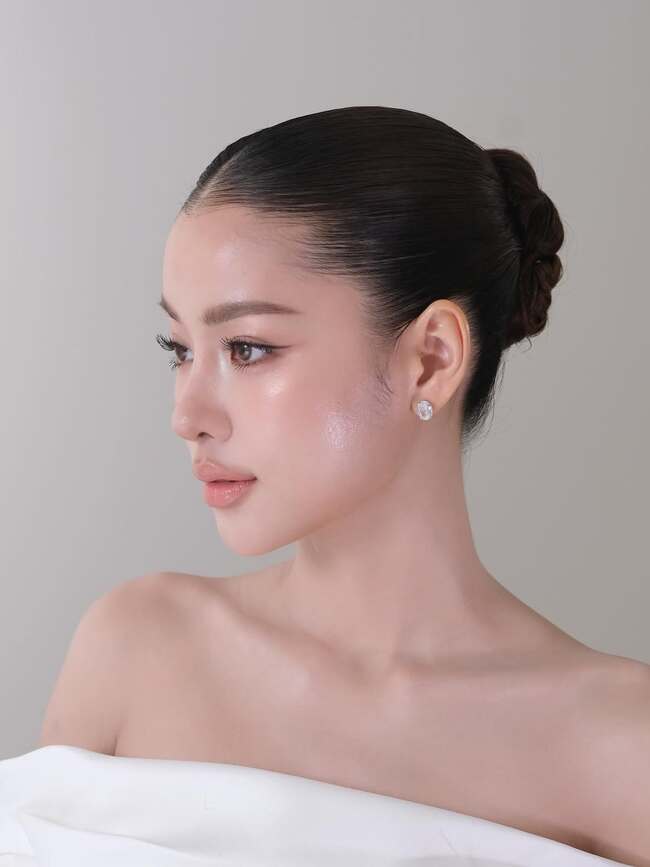 Refined nude makeup with dewy finish and classic updo