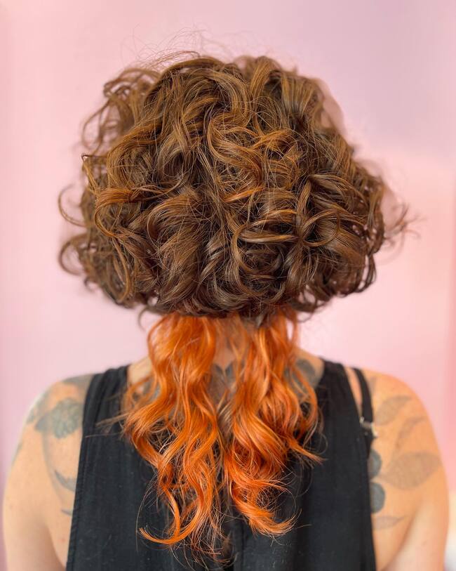 Curly jellyfish haircut with auburn bowl and redhead passes
