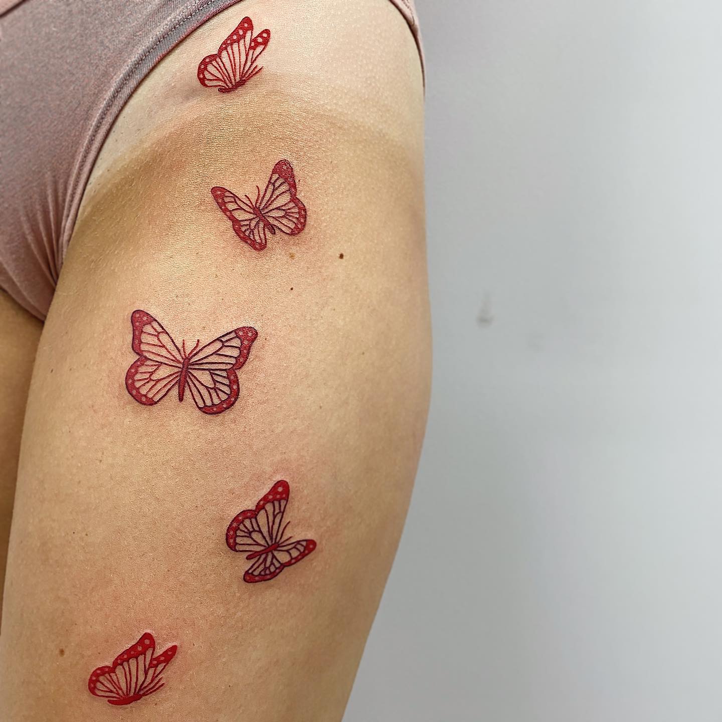 Flying red butterflies on hip