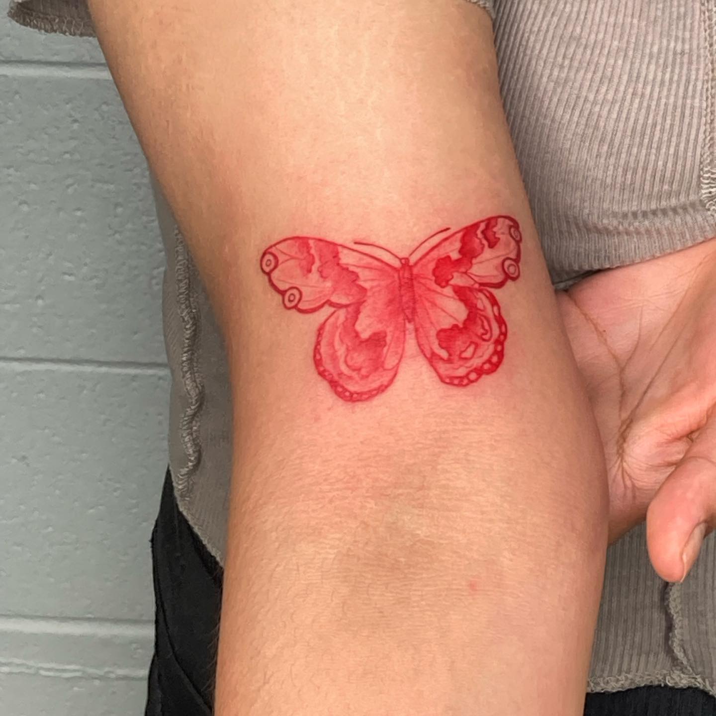 Bold red butterfly tattoo