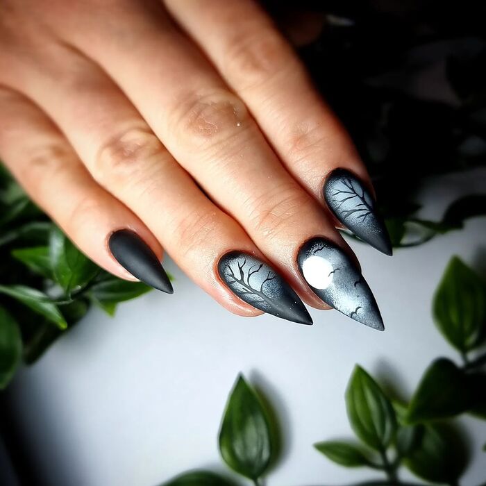 Close-Up Photo of Matte Black Ombre Nails With Designs
