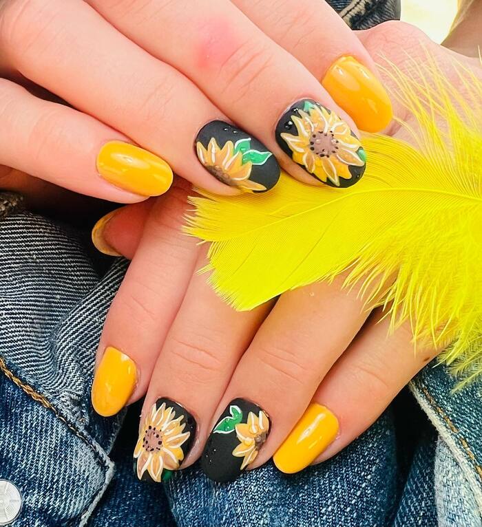 Close-Up Photo of Matte Black Natural Nails With Sunflowers