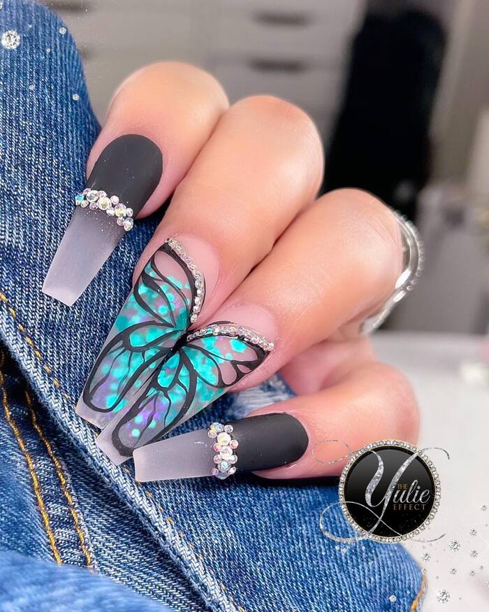 Close-Up Photo of Matte Black Nails With Butterflies