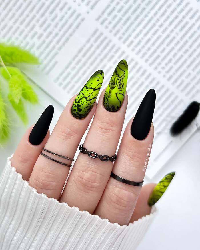 Close-Up Photo of Black And Neon Green Almond Nails