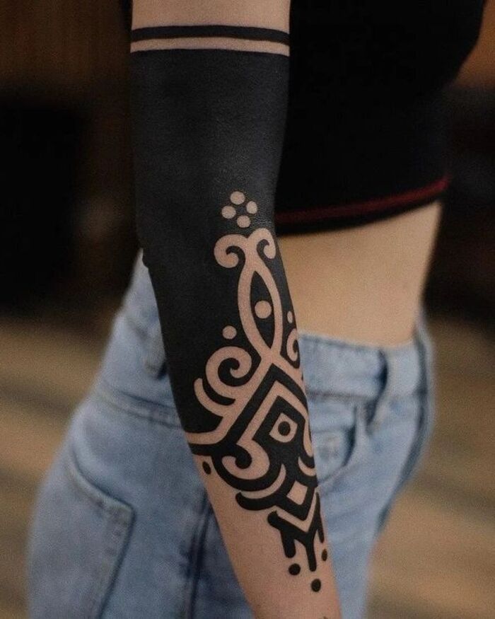 Unalome blackout arm tattoo