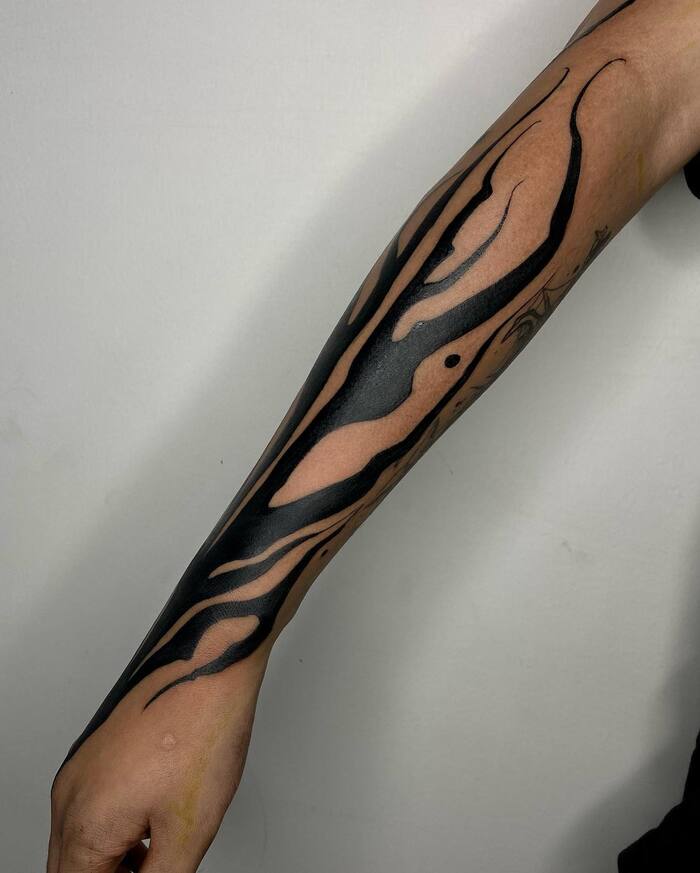 Simple blackout forearm tattoo