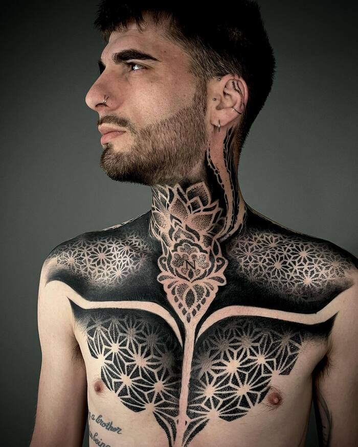 Neck and chest blackout men tattoo