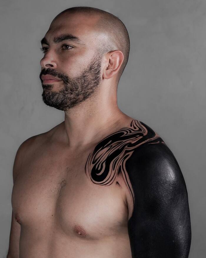 All black shoulder blackout tattoo for men