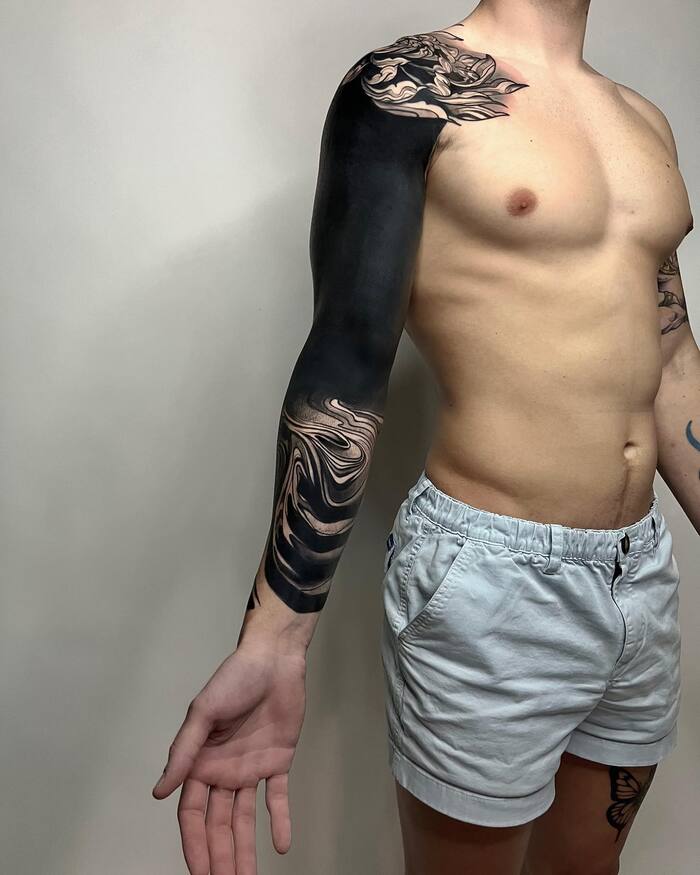 Abstract blackout sleeve tattoo