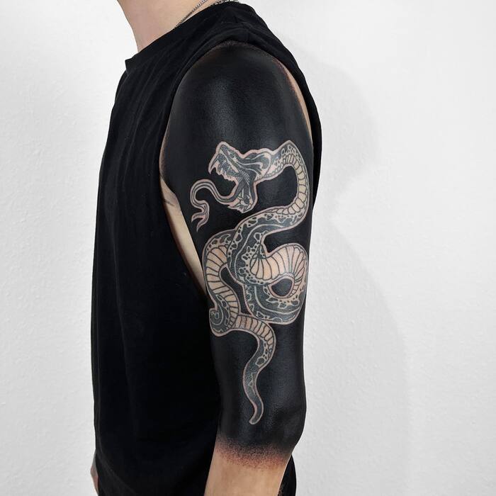 Snake blackout shoulder tattoo