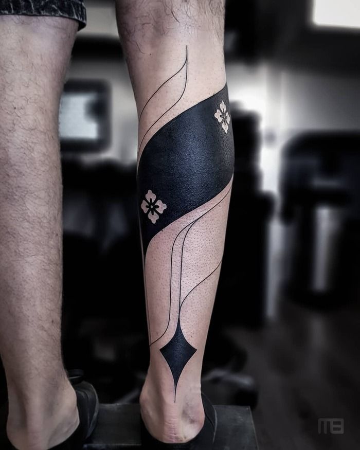 Blackout minimalist tattoo on leg