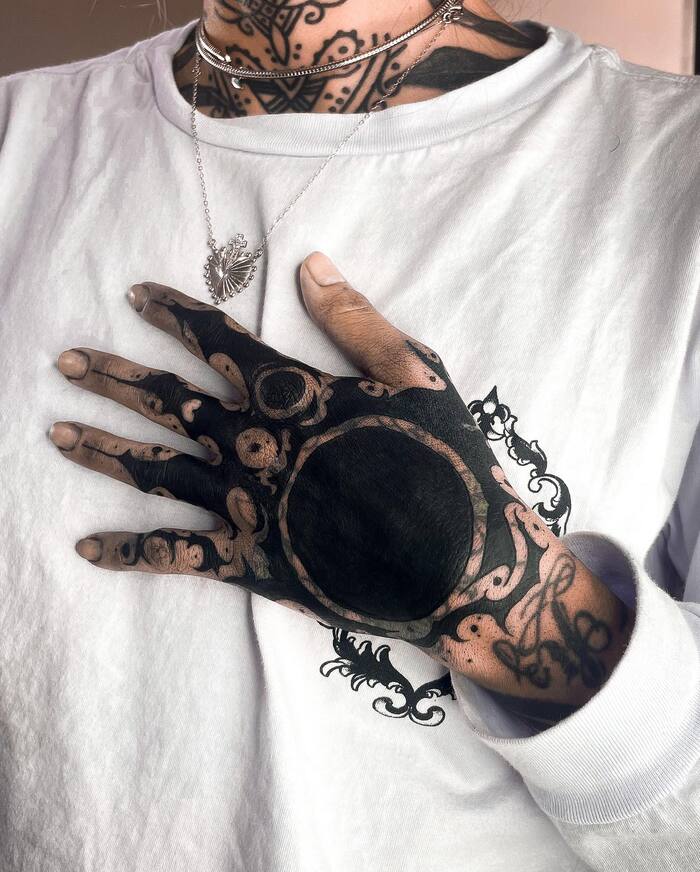 Blackout hand and fingers tattoo