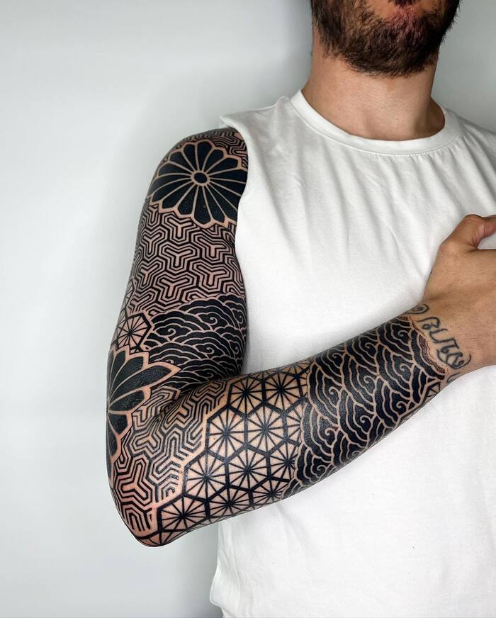 Blackout tattoo with geometric patterns