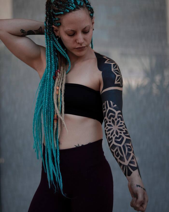 Female blackout mandala sleeve tattoo
