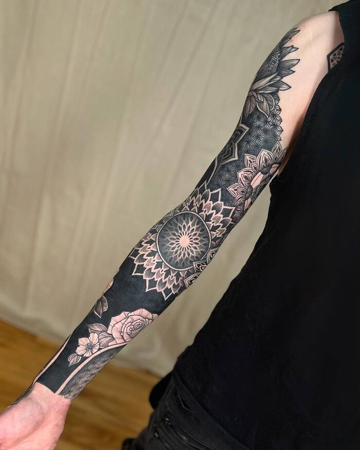 Blackout mandala and flowers tattoo