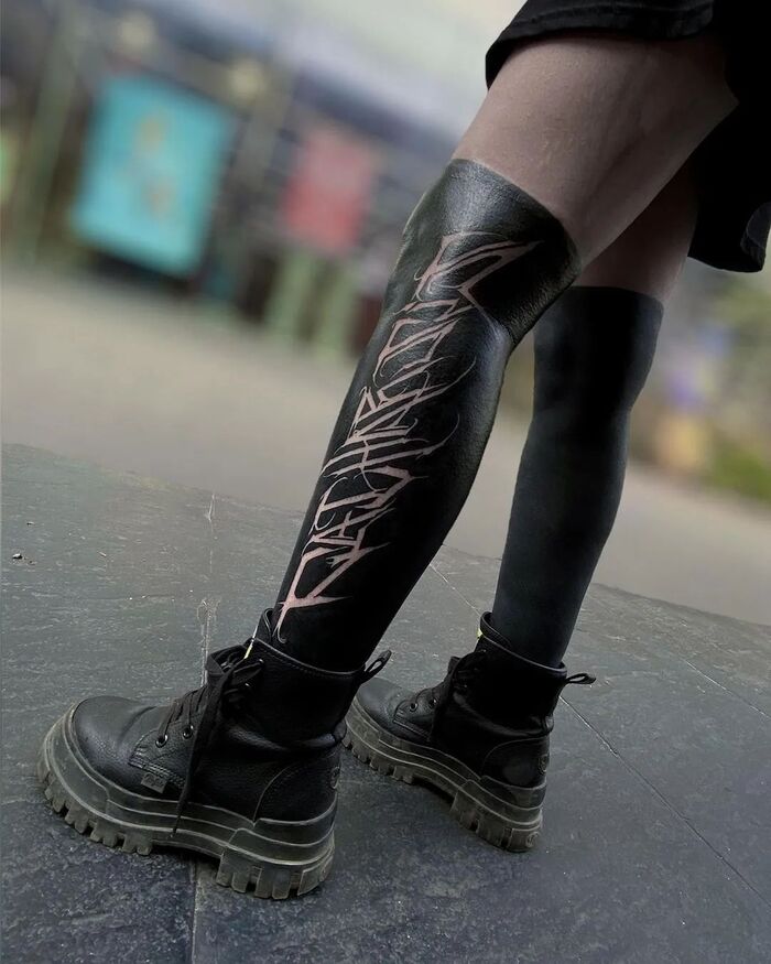 Socks blackout tattoo on both legs