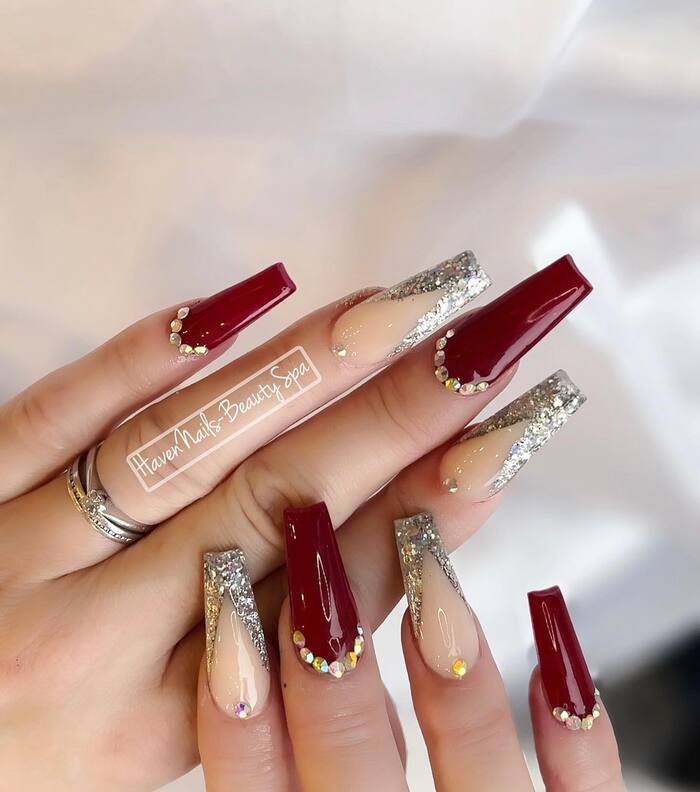 Glam nails with burgundy gel polish and lot of sparkles