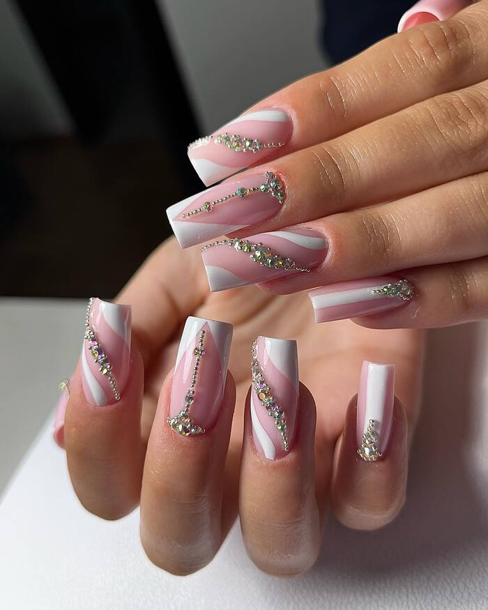 Pink and white bridal nail art with lot of diamonds