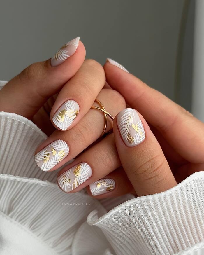Short matte nails with white and gold paintings