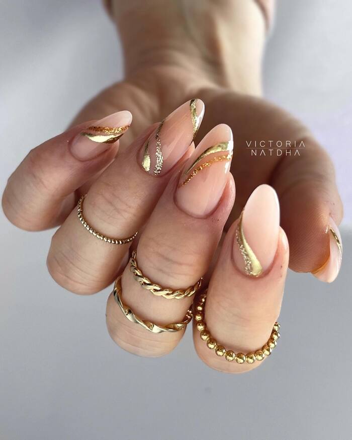 Wedding nails with nude base and golden stripes