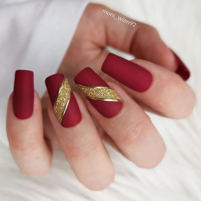 Matte red wedding manicure with gold stripes