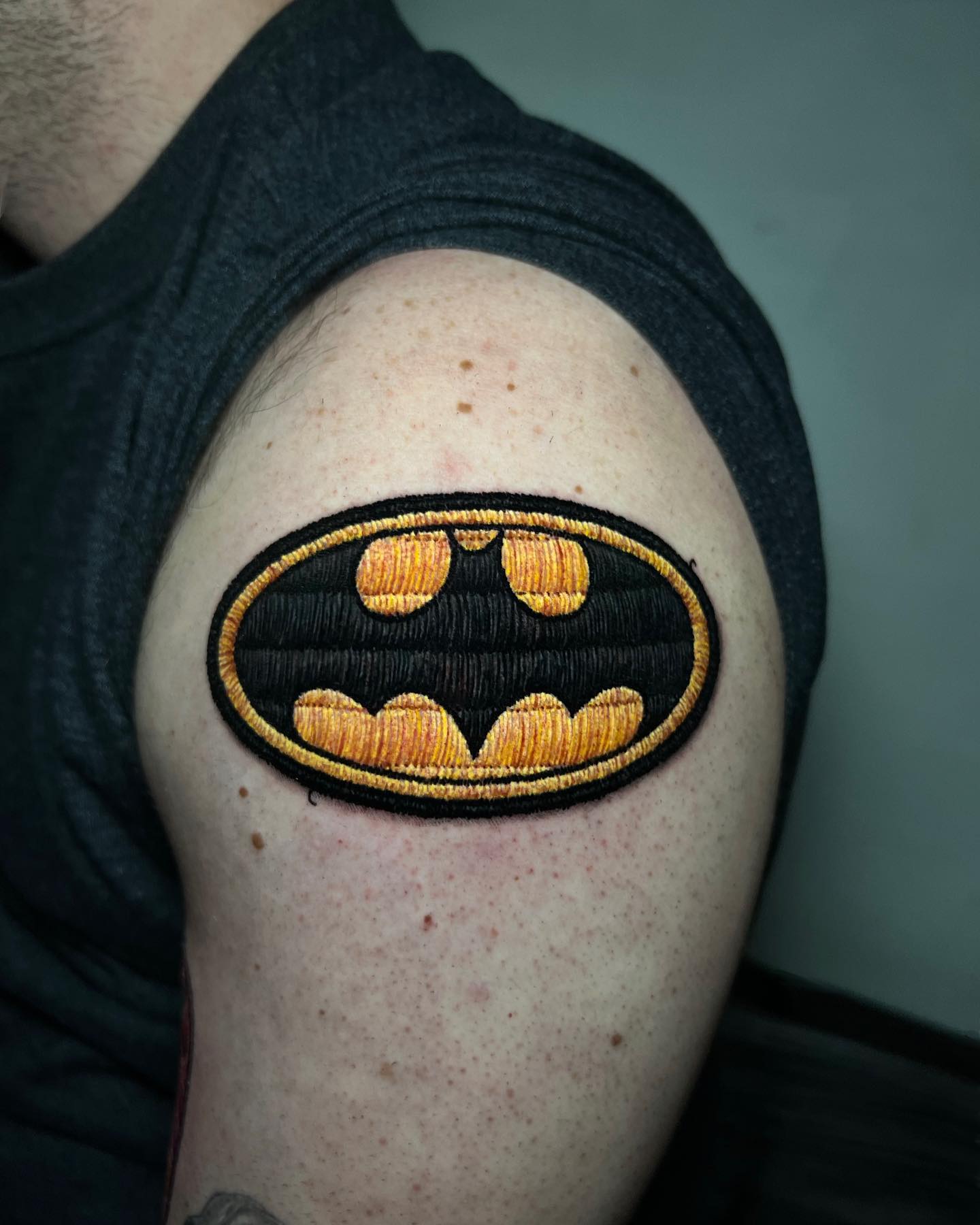 Batman patch tattoo on shoulder 