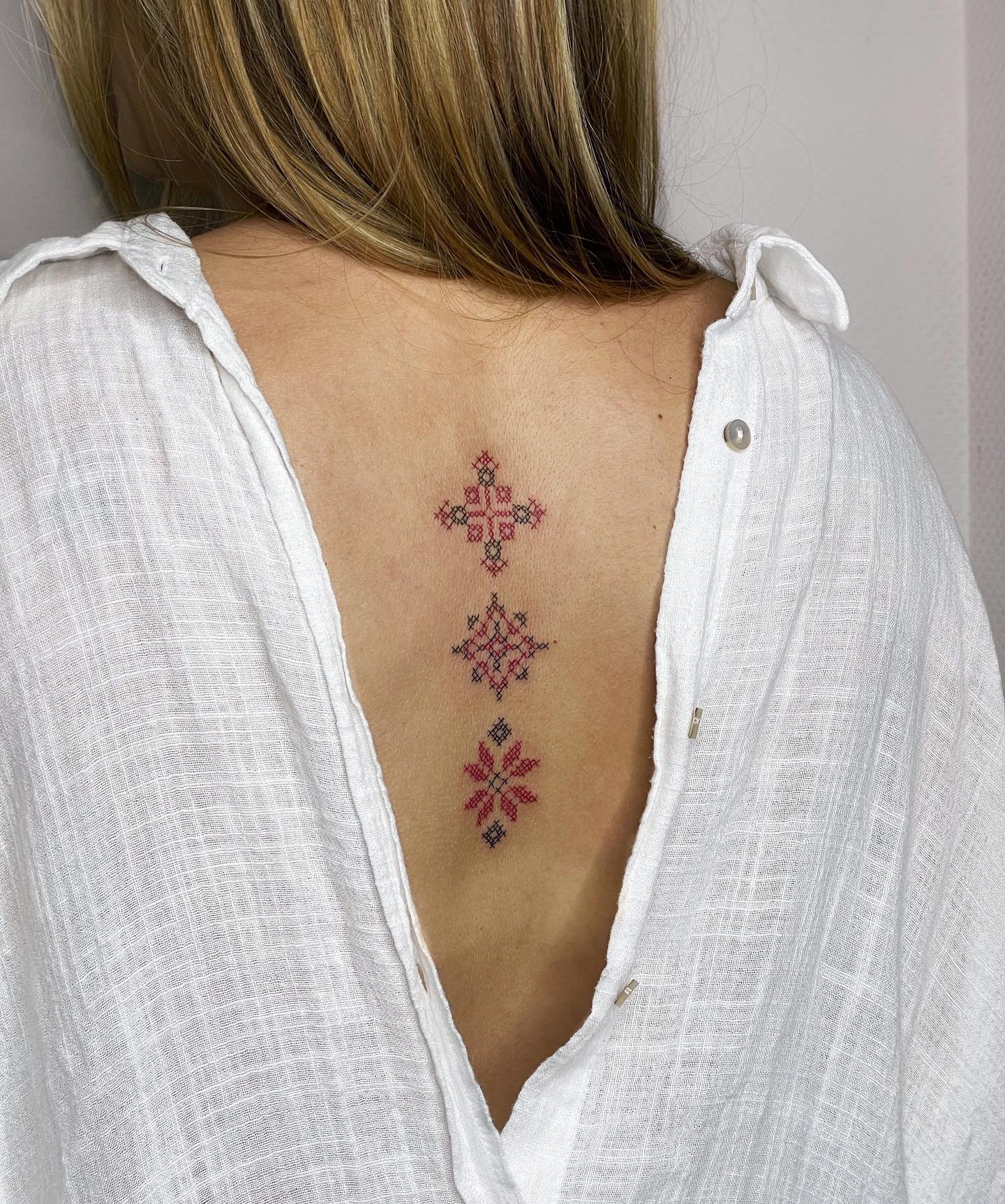 Ukrainian cross embroidery tattoo on back