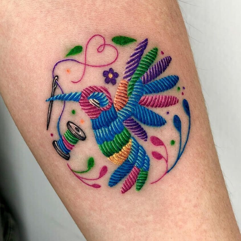 Hummingbird tattoo with threads and needle