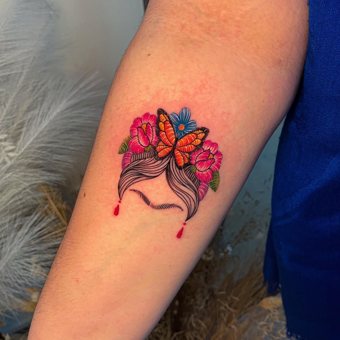 Mexican tattoo of Frida Kahlo's forehead with embroidery elements