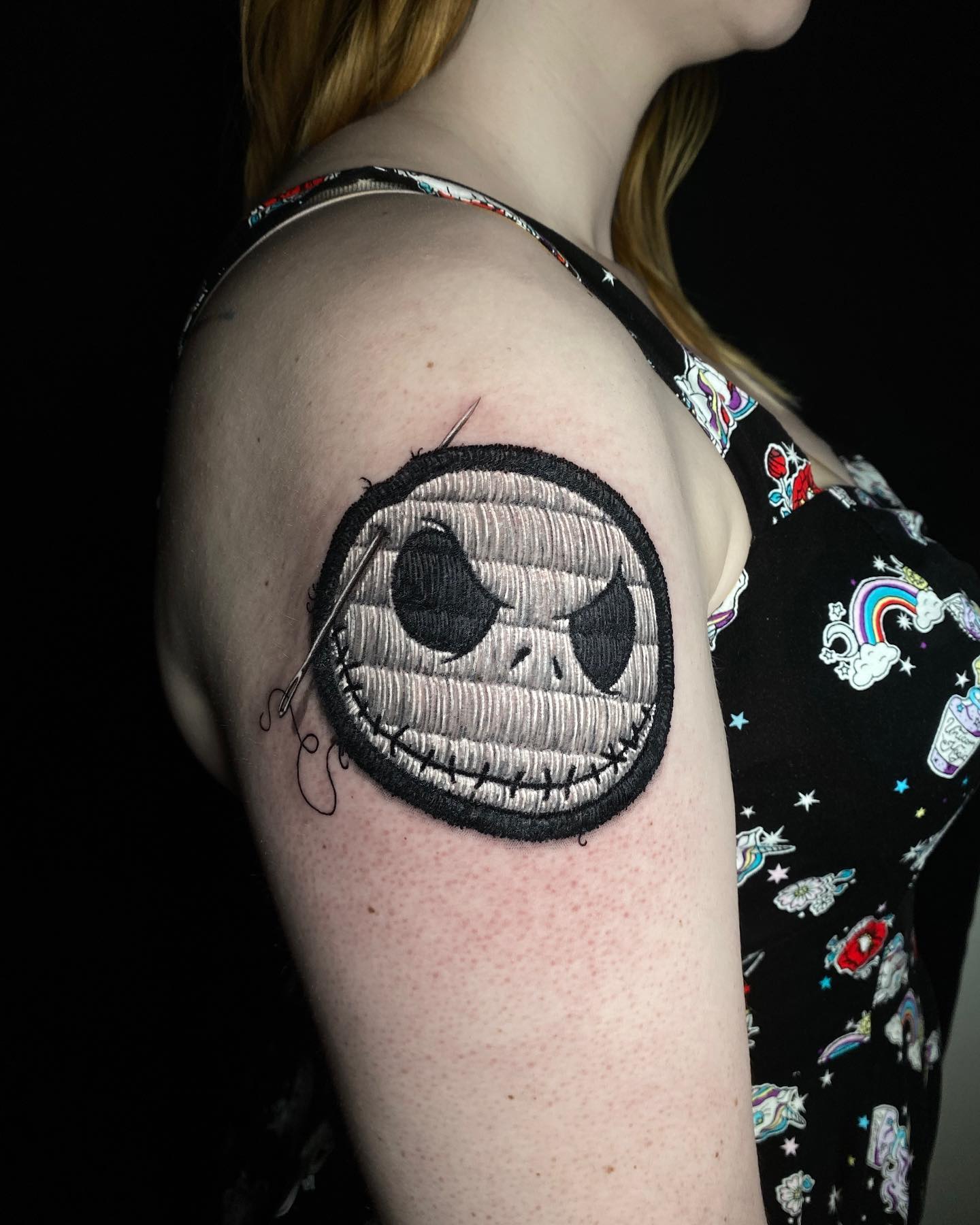 Black and white embroidery stitch tattoo of evil smile