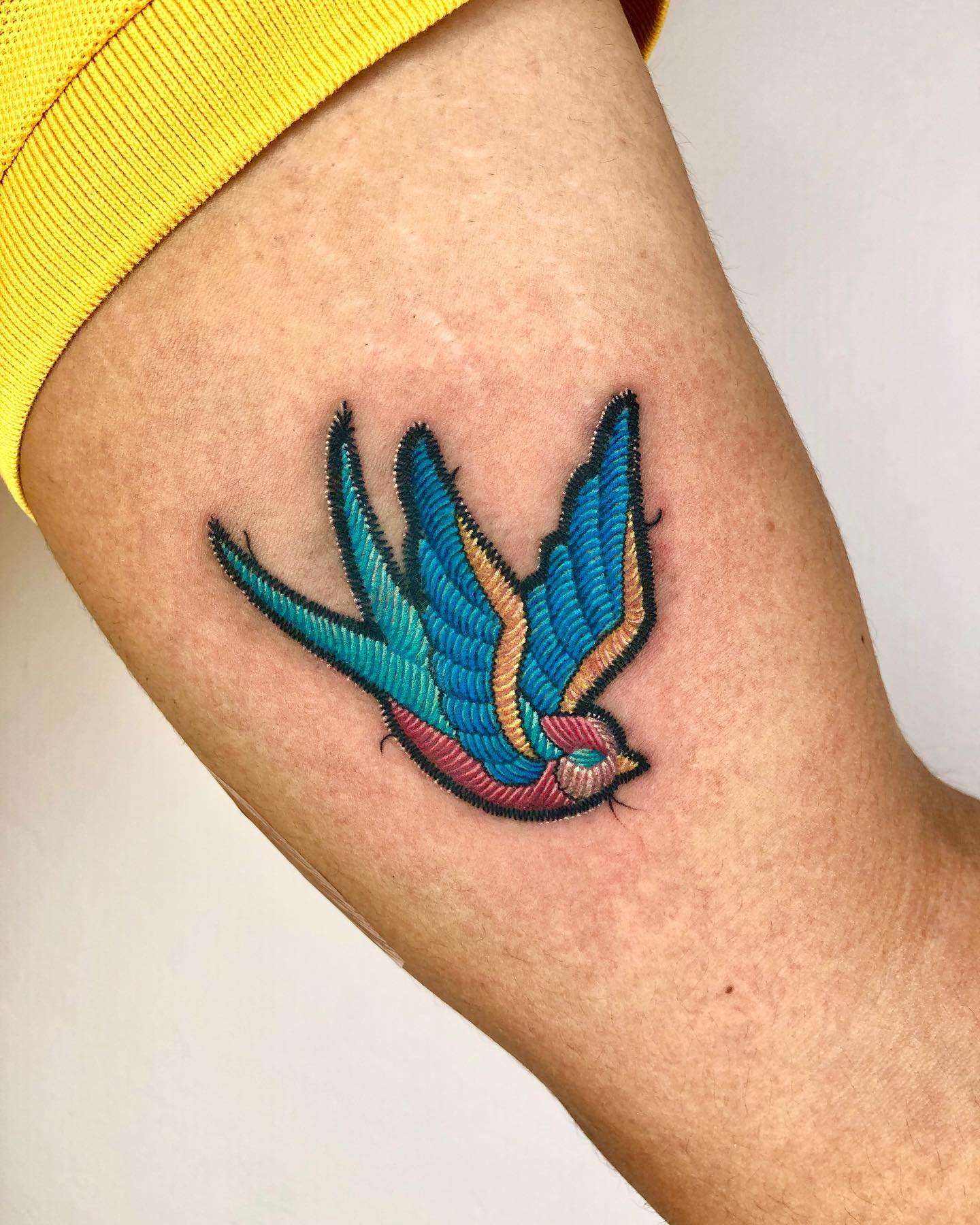 Tattoo with flying hummingbird in combination of old school and embroidery techniques 