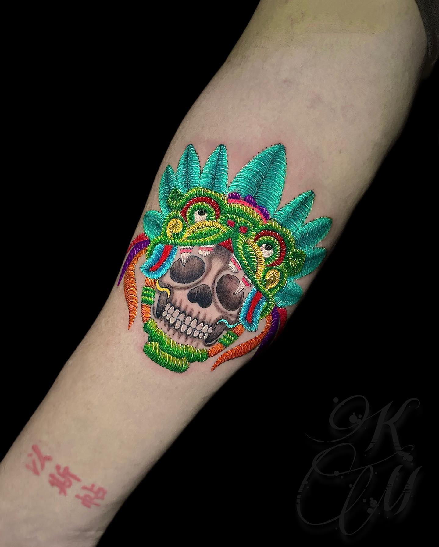 Gray skull with stitch headdress tattoo