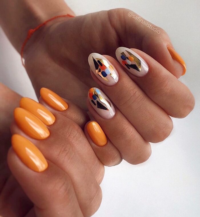 Close-up photo of Pretty Orange Fall Nails With Geometric Patterns