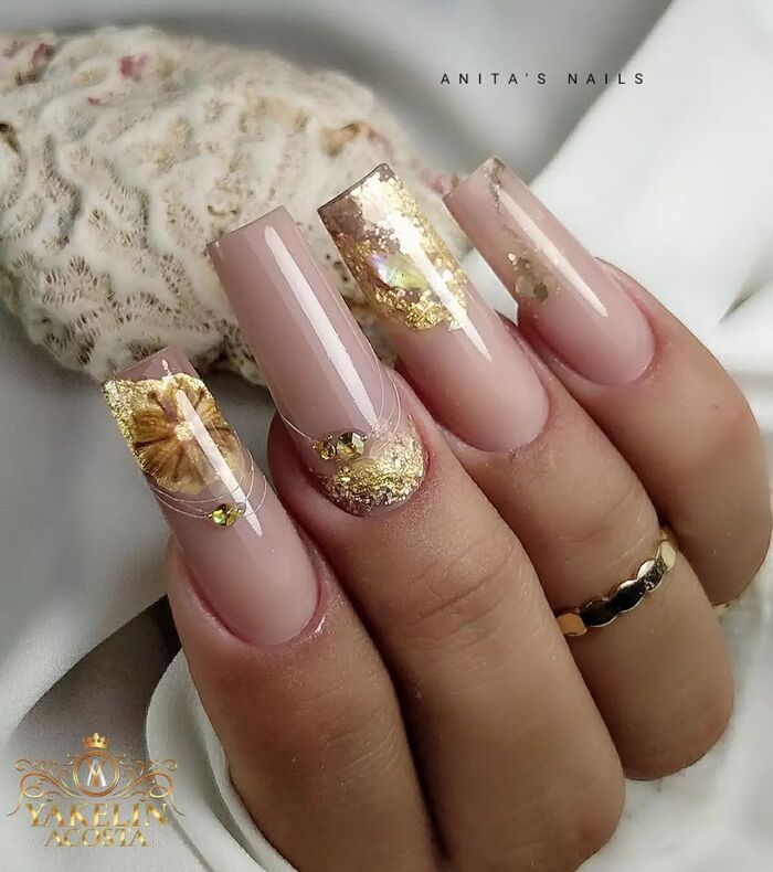 Close-up photo of Classy Nude Coffin Nails With Golden Foil