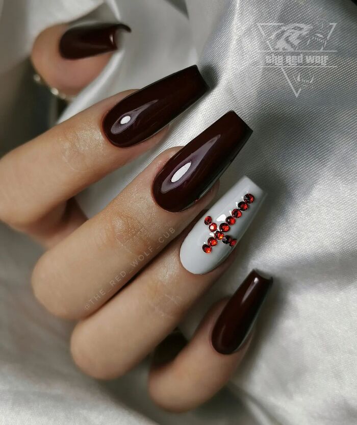 Close-up photo of Burgundy Coffin Nails With White Accent