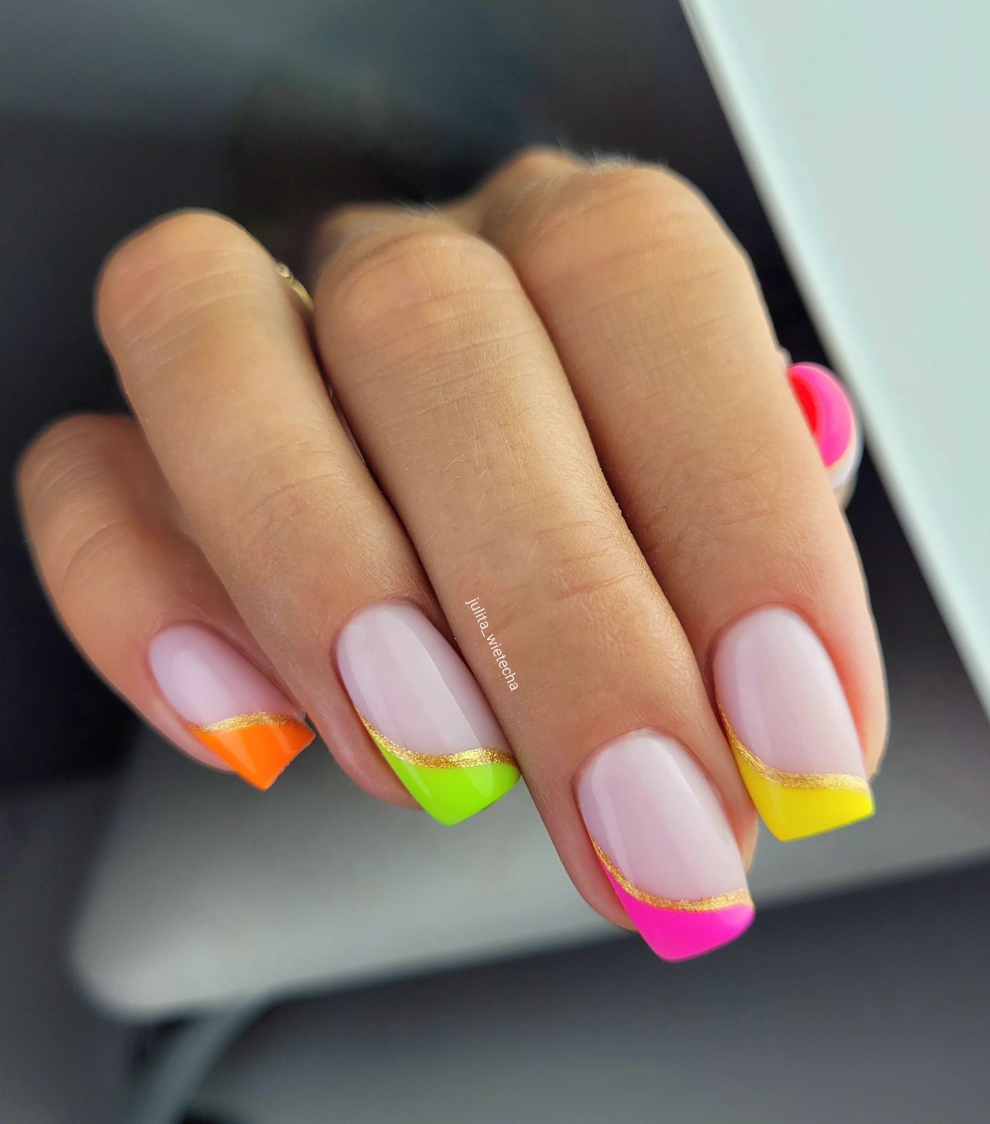 square nails with rainbow french tips, separated by gold wavy line