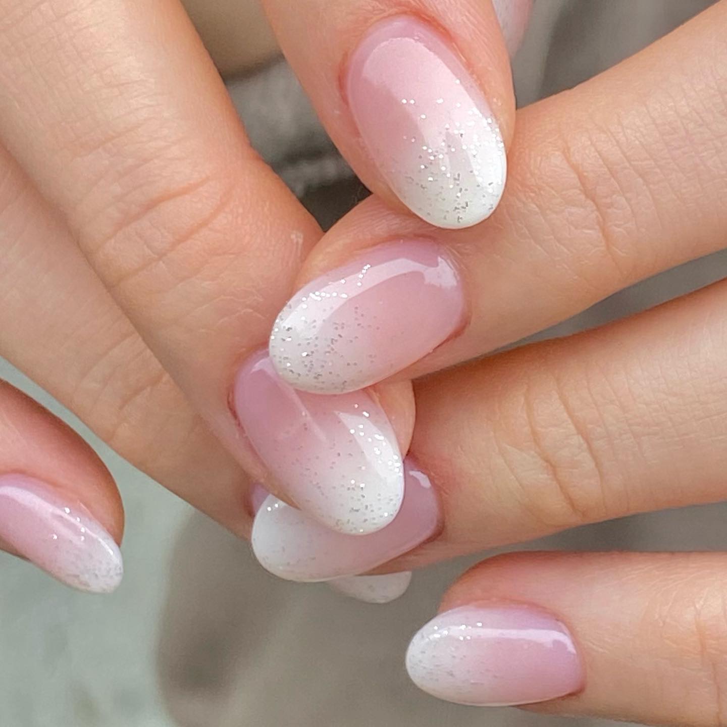 Pink and white french ombre nails with glitter