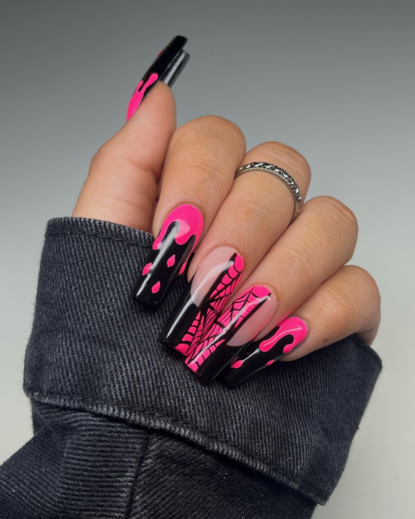 Another example of Halloween nails with pink and black matte or glossy designs