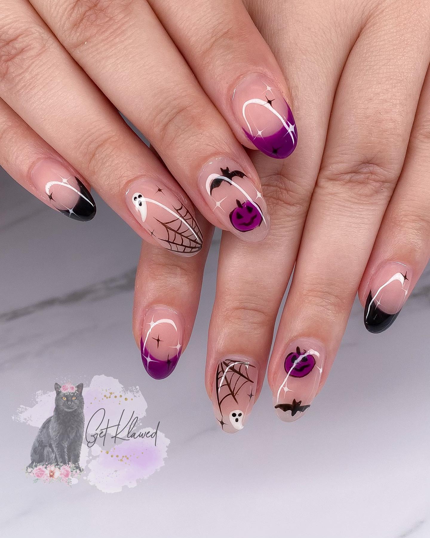 Halloween nails with transparent base and ghost, bats and pumpkins drawings