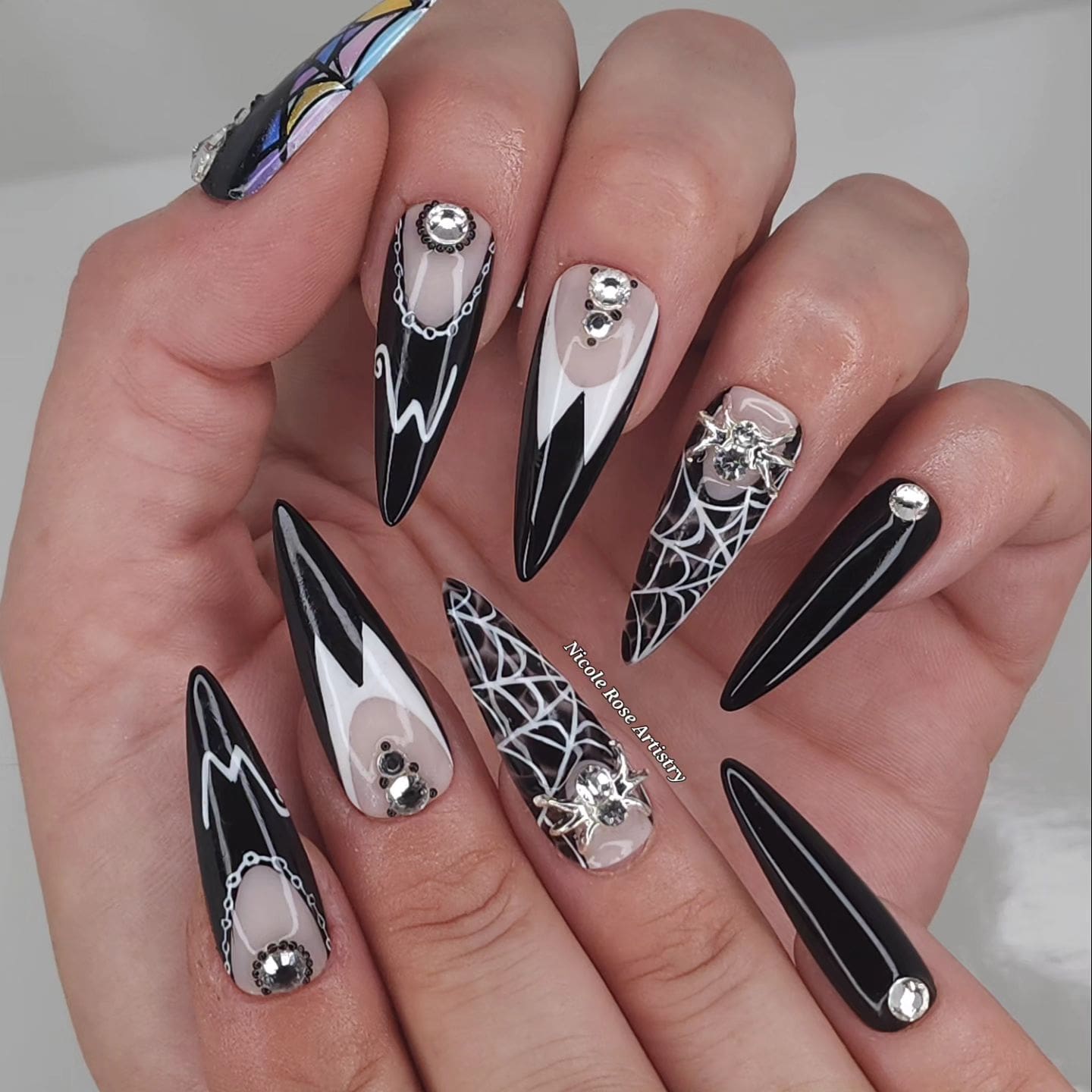 One more photo of white or silver spider web in glossy black almond or coffin shaped nails